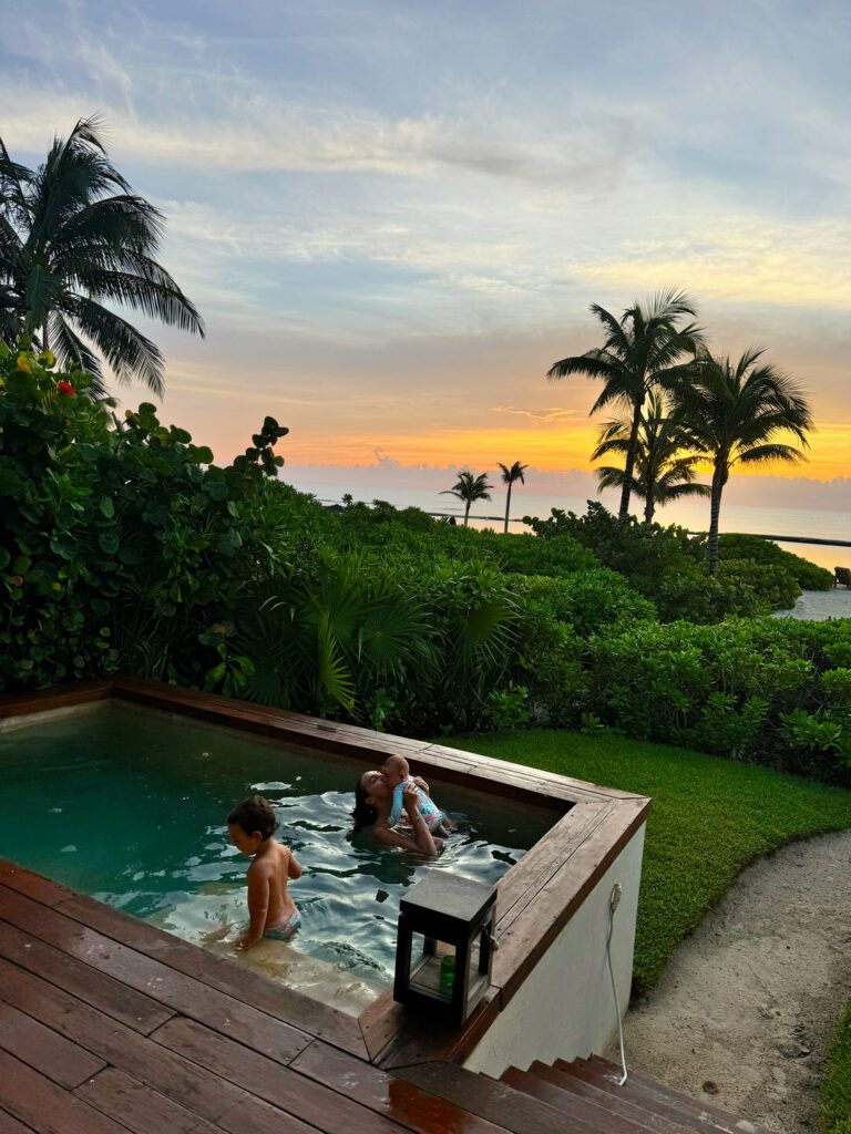 Kids in a private plunge pool at sunset at Rosewood Mayakoba