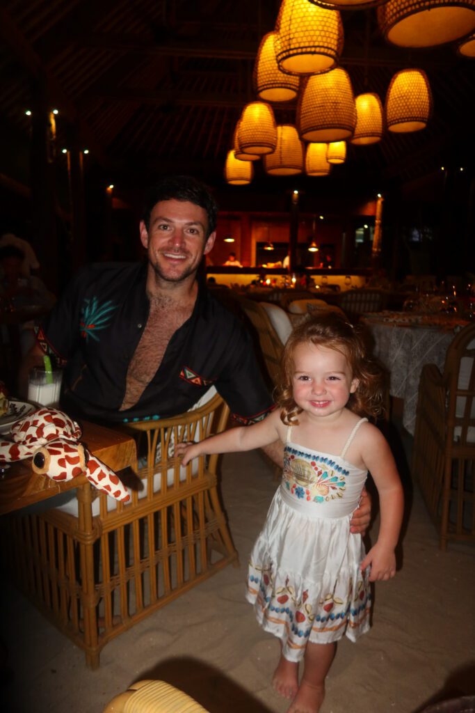 Toddler at dinner under the lanterns at NIHI Sumba