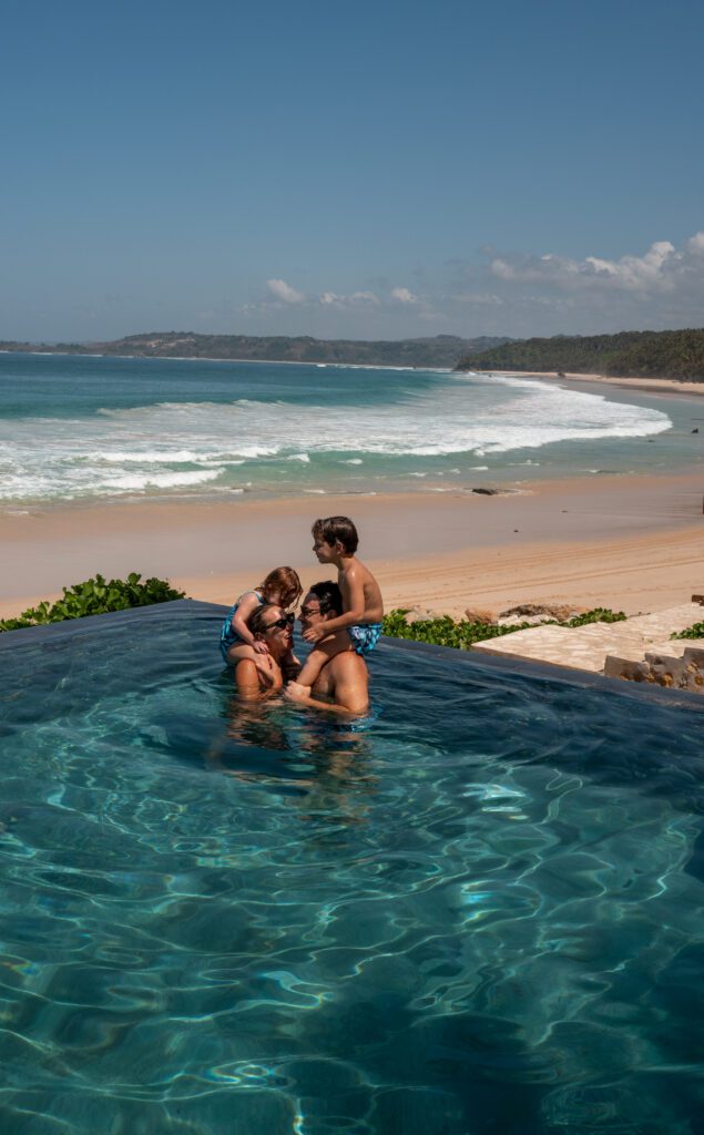 Family in the infinity pool at NIHI Sumba