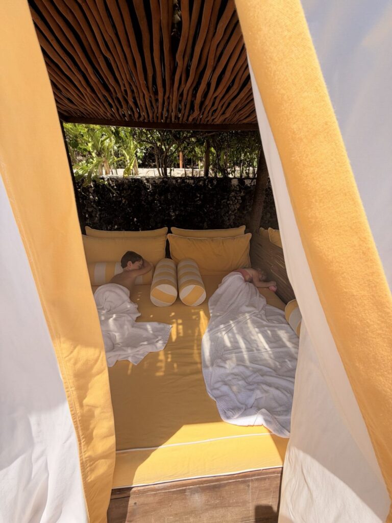 Kids relaxing on a cabana daybed at NIHI Sumba