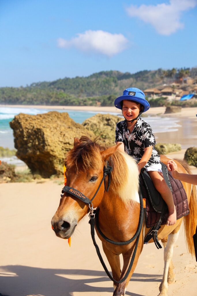 Our son on a pony ride on the beach at NIHI Sumba, Indonesia